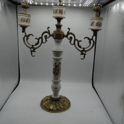 Candle holder with dancing women design.