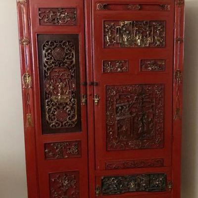 Antique red and black lacquer Chinoiserie Wedding Cabinet, with expertly hand carved Chinese Icons â€“ fish for prolific newlyweds.
