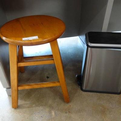 Small wooden step stool and small trash can.