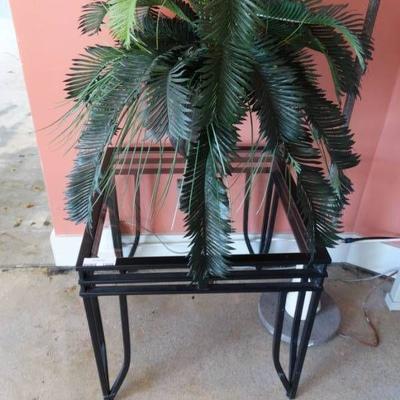 Metal side table with glass top with faux plant.