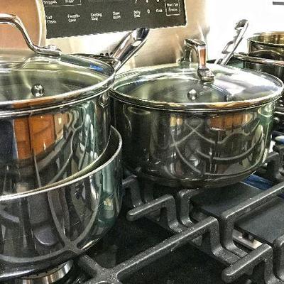 All-Clad Stainless Steel Tri-Ply Bonded pot and pan. And two Emeril Lagasse pots.