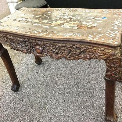 This is an unusual and exceptional Chinese table! Made of exotic hard wood and inlay of mother of pearl and abalone. Carvings on the side...