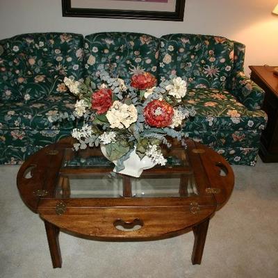 Oval Drop Sides with Beveled Glass Coffee Table. Green Floral Motif Sofa 