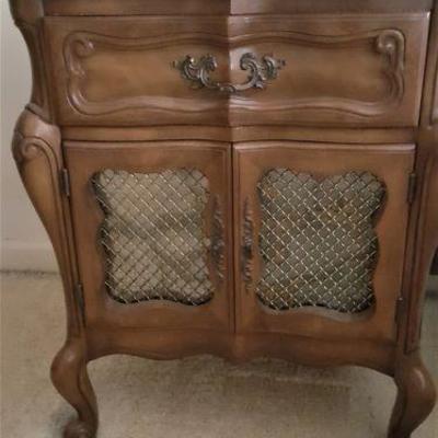 One of a pair of matching nightstands that are a part of the bedroom set.  Each cabinet has mirror on back side of doors. 