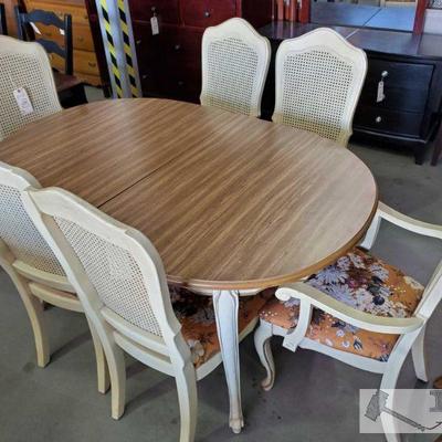 290: Seven Piece Wood Dining Set
Six cream/orange colored cushion chairs w/ floral pattern, table with brown/cream color


