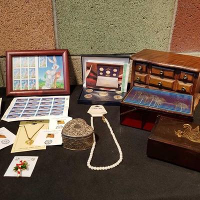 751: Jewelry Boxes, Stamps, Coins, Pins, and More
Bugs Bunny stamps, 2000 24kt gold plated proof set. 2 plastic jewelry boxes and 1 wood.