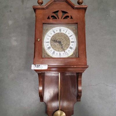 333: Wood Wall Clock with Pendulum Swinging weight
Antique Wall clock with detailed clock face and pendulum arm