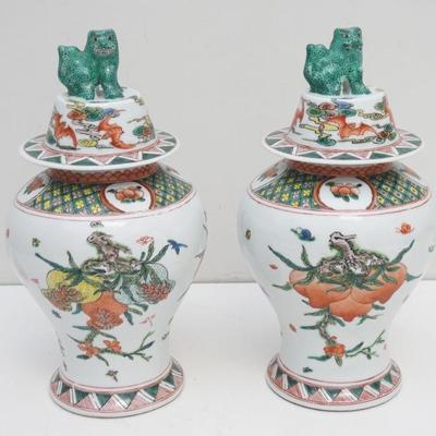 A pair of Chinese Porcelain Covered Jars. Foo dog finials, bodies with peach and pomegranates, lids with 5 bats representing good fortune...