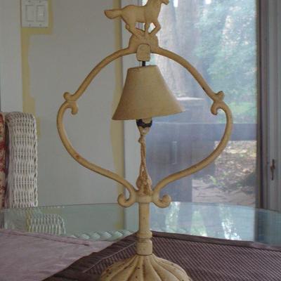 Vintage ornate cast iron bell and stand with horse display