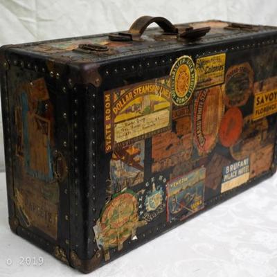 antique traveling trunk with world's stickers