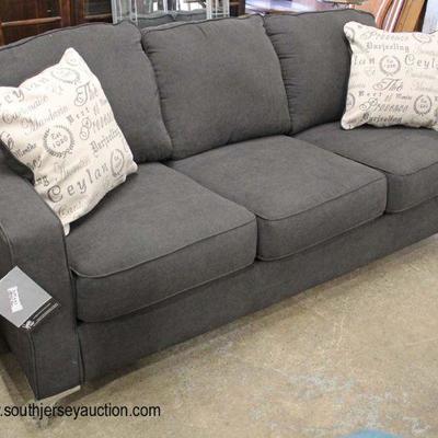 NEW Signature â€œAshley Furnitureâ€ Slate Grey Sofa with Accent Pillows

Auction Estimate $200-$400 â€“ Located Inside