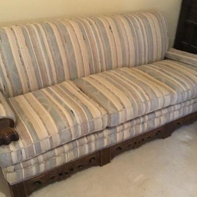Vintage Circa 1930's Sofa with wood Carvings on Bottom.  Matching chair available.  Very ,very heavy frame