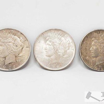 1105: 2 1922, 1934-D Peace Silver Dollars
2 1922 Philadelphia Mint and 1934 Denver Mint Silver Peace Dollars