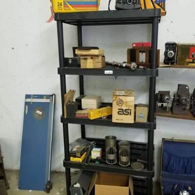 All items on black shelf- Polaroid, film box coole ...