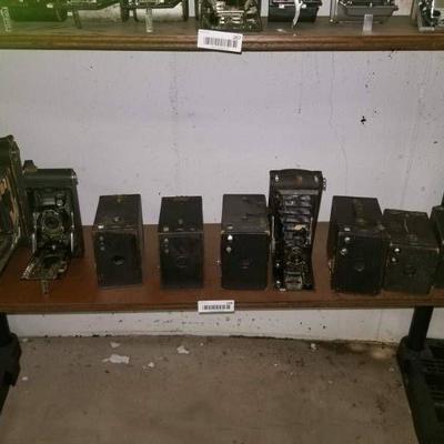 Bottom shelf of 9 cameras- 3 folding bellows Kodak ...