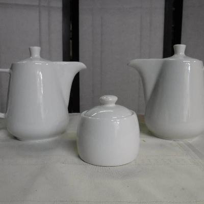 #pair of white tea pots with sugar dish