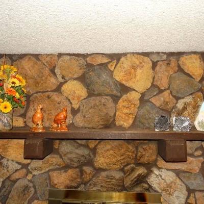 Lot of assorted decor on fireplace mantel