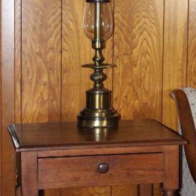 Vintage end table with single drawer and lower shelf (22â€W x 18â€D x 26â€H), shown with tall brass table lamp (1 of 2 shown)