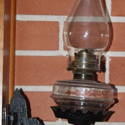 Antique black wrought iron adjustable arm holder with oil lamp