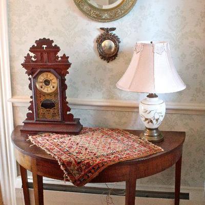 demilune table, mantle clock, small rug, beveled and convex mirrors