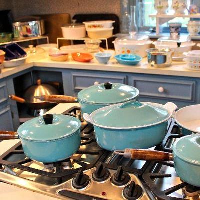 extensive collection of kitchen items, including turquoise Le Creuset and other enamel over cast iron cookware, a wok, stainless steel...