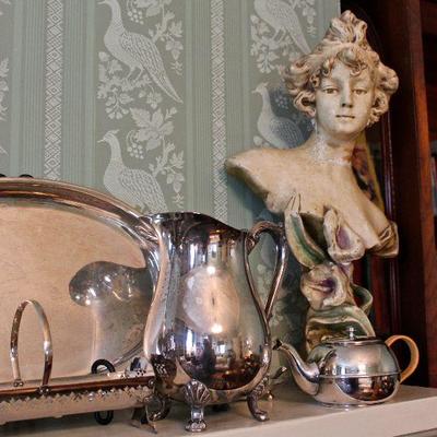collection of silver plated pieces, including pitchers, vessels, and trays