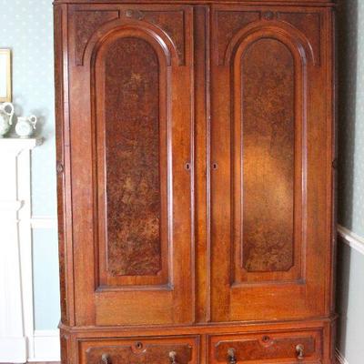 antique wardrobe with drop pulls on the bottom drawers