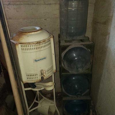 1250: Vintage Sparkletts Water Cooler with 4 Glass 5 Gallon Jugs and 3 Wood Crates
Vintage Sparkletts Water Cooler with 4 Glass 5 Gallon...