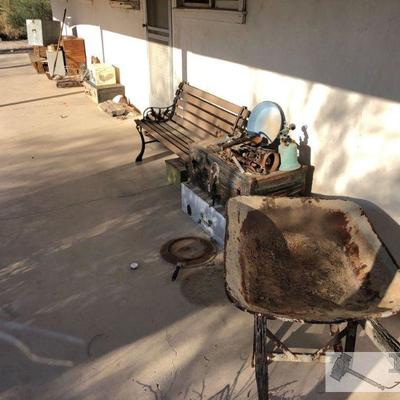 2875: Porch Full of vintage items
Vintage wheel barrow, trunks, bench, ceramic pans, ammo box, vintage Cooler, petrified wood and rocks,...