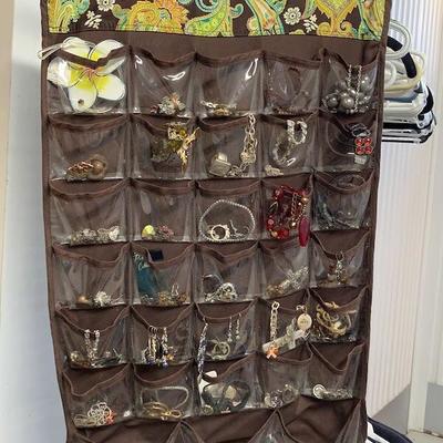 Two sided jewelry organizer filled with jewelry. 
View all 100+ lots at https://texastauctions.com