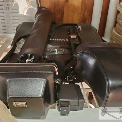 1002: 	
2 Canon Camers, Canon Typest Type Writer and Camera Lens
Includes a tripod, flash, Canon cameras and lens.