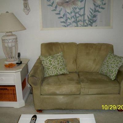 Sage Green Micro Suede Loveseat. ; Broyhill White End Table with Wicker Basket Storage,; Table Lamp.