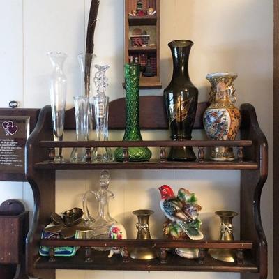 Vases and candle holders on a wall shelf