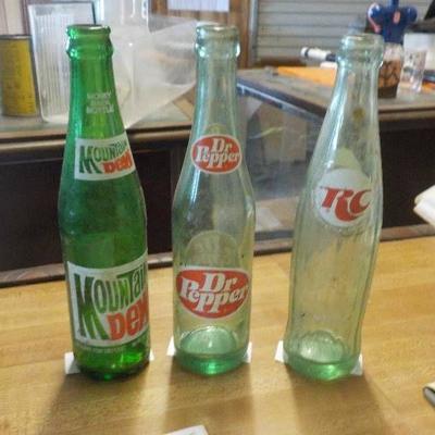 three vintage soda bottles