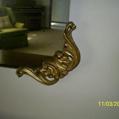 Close up of Brass Corner on Mirror
