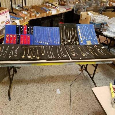 large lot of assorted necklaces on displays