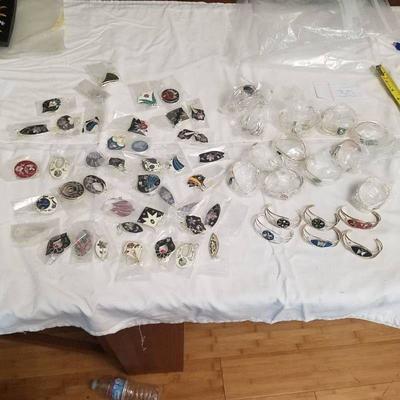 approximately 30 bracelets and 40 sets of earrings