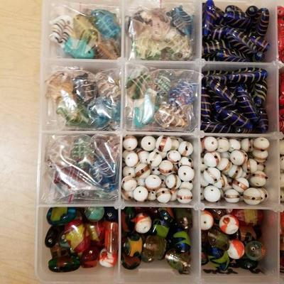 two organizer containers full of fancy necklace be ...