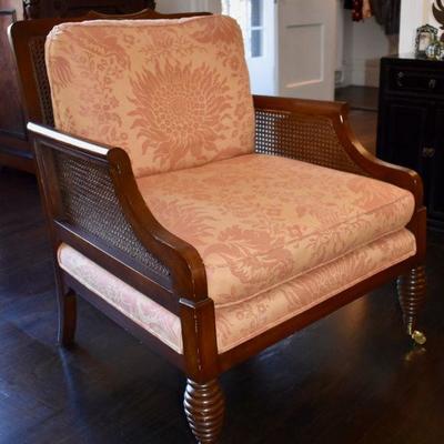 One of a pair of caned arm chairs