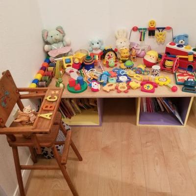 Infant toys, books and vintage doll high chair.