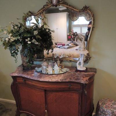 antique French marble top commode, antique mirror, floral arrangement