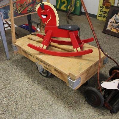 RED ROCKING HORSE SITTING ON WOODEN LINEBERRY CART STYLE.  NOT LINEBERRY