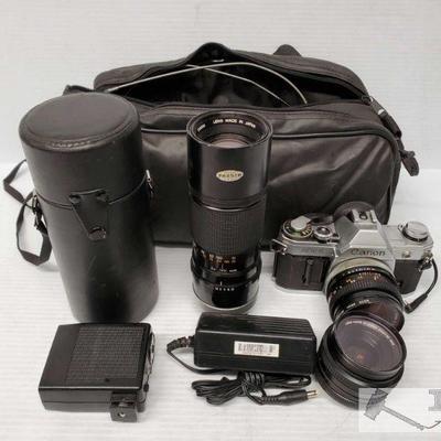 9061: Canon Camera w/ 3 various lenses, Charger, Flash and Carry bag
Canon AT-1 Camera w/ 3 various lenses. Wire button push, charger and...
