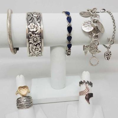 1241:Five Sterling Silver Bracelets and Four Sterling Silver Rings, 141.6g
Combined weight approx 141.6g, ring sizes range from 6.5-9 and...