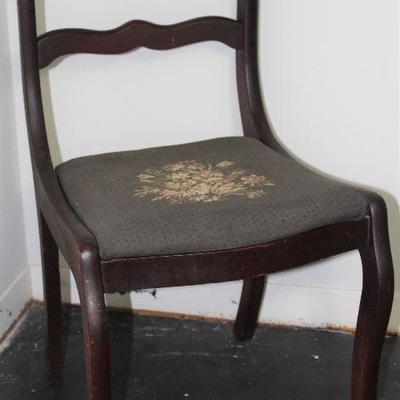 Antique mahogany rose back side chair with needlepoint upholstered seat.