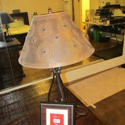 Wrought-iron desk lamp with a custom metal shade that has blue glass beadwork.