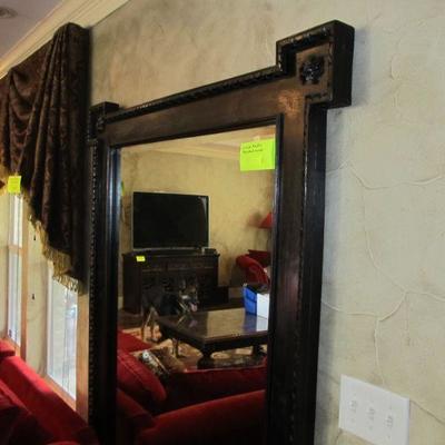 Large oversized beveled mirror in a rustic thick wooden frame w/ decorative medallions in each corner.  A statement piece for sure!  (TV...