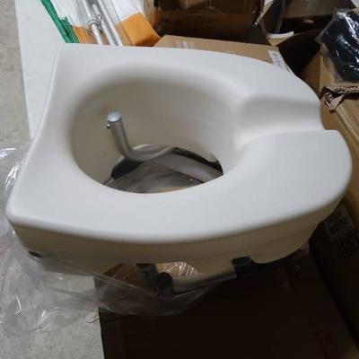 Elevated toilet seat with rails.