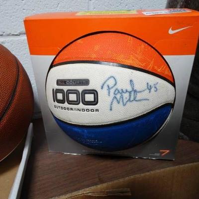 Signed basketball in box.
