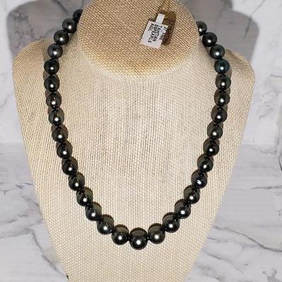 Cultured Tahitian Pearl Necklace
Individually hand knotted. Finished with 14K white Gold Plunger Style Bead Clasp. Measures 17.5inches in...